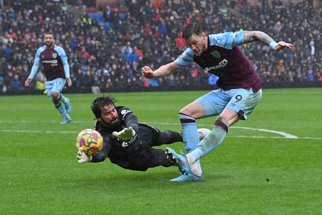 Liverpool keeper Alisson Becker makes a save from Burnley’s Wout Weghorst. Picture: PAUL ELLIS/AFP via Getty Images