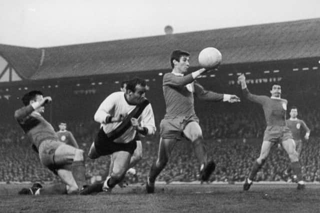 A tense moment for Liverpool players Tommy Smith (left) and Geoff Strong (second from right) as Inter-Milan player Mario Corso lunges in with a header during an attack by the Italian side in a semi-final, first leg match at Anfield, 5th May 1965. Photo: Central Press/Hulton Archive/Getty Images