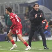 Simone Inzaghi applauds Hakan Calhanoglu from the sideline during the Champions League tie with Liverpool.