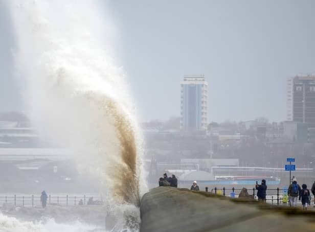 <p>People view the waves created by high winds and spring tides hitting the sea wall at New Brighton promenade on February 17, 2022 in Liverpool, England</p>