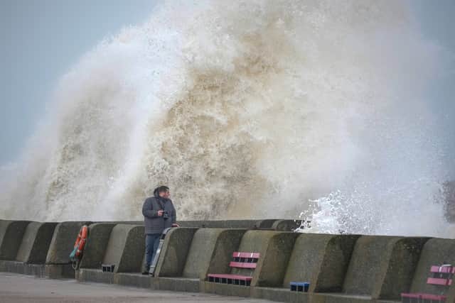  People view the waves created by high winds and spring tides hitting the sea wall at New Brighton promenade on February 17, 2022 in Liverpool, England. A red alert has been declared for Storm Eunice which is arriving in the early hours of Friday in the wake of Storm Dudley. Picture: Christopher Furlong/Getty Images
