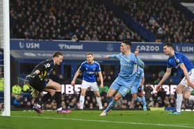 LIVERPOOL, ENGLAND - FEBRUARY 26: Phil Foden of Manchester City scores their team’s first goal past Jordan Pickford of Everton during the Premier League match between Everton and Manchester City at Goodison Park on February 26, 2022 in Liverpool, England. (Photo by Michael Regan/Getty Images)