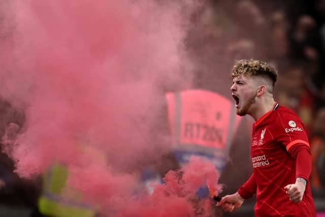 Harvey Elliott of Liverpool celebrates with a red flare. Pictue: Michael Regan/Getty Images
