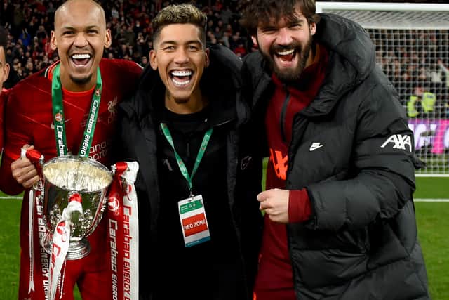 Roberto Firmino, centre, with Fabinho, left and Alisson Becker after Liverpool’s Carabao Cup triumph. Picture: Andrew Powell/Liverpool FC via Getty Images