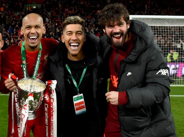 Roberto Firmino, centre, with Fabinho, left and Alisson Becker after Liverpool’s Carabao Cup triumph. Picture: Andrew Powell/Liverpool FC via Getty Images
