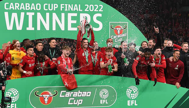 Jordan Henderson lifts the trophy as Liverpool win the 2022 Carabao Cup. 