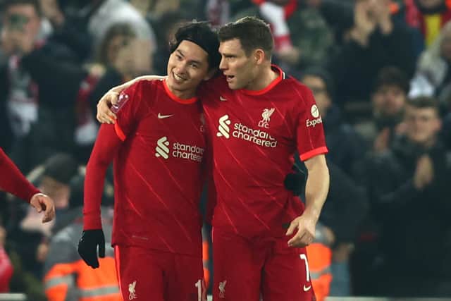 Takumi Minamino celebrates with James Milner after scoring for Liverpool against Norwich. Picture: Clive Brunskill/Getty Images