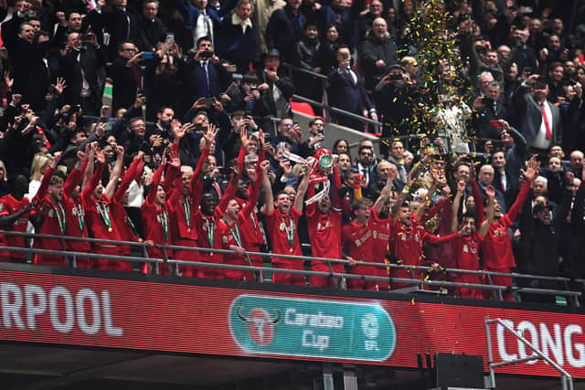 Jordan Henderson of Liverpool lifts the Carabao Cup trophy following victory in the Carabao Cup Final match between Chelsea and Liverpool at Wembley Stadium on February 27, 2022