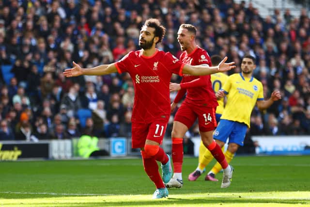 Mohamed Salah of Liverpool celebrates with teammate Jordan Henderson after scoring their team's second goal from the penalty spot during the Premier League match between Brighton & Hove Albion and Liverpool at American Express Community Stadium on March 12