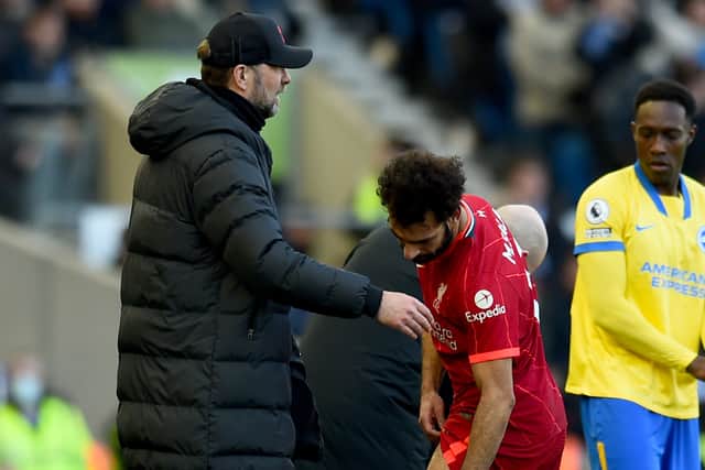 Mo Salah shows Jurgen Klopp his injury during Liverpool’s defeat of Brighton. Picture: Andrew Powell/Liverpool FC via Getty Images