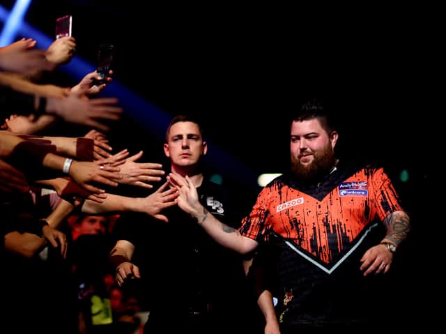 <p>Michael ‘Bully Boy’ Smith of England walks out before he competes against Michael ‘Mighty Mike’ van Gerwen of Netherlands. Photo: Dean Mouhtaropoulos/Getty Images</p>
