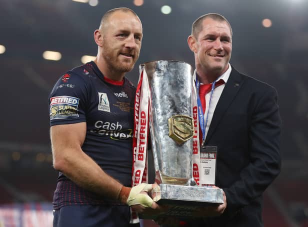 <p>James Roby of St Helens holds the Grand Final Trophy with head coach Kristian Woolf. Photo: Lewis Storey/Getty Images</p>