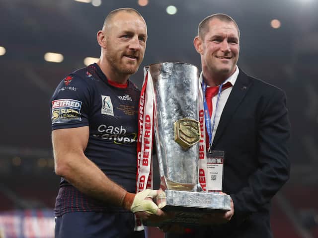 <p>James Roby of St Helens holds the Grand Final Trophy with head coach Kristian Woolf. Photo: Lewis Storey/Getty Images</p>