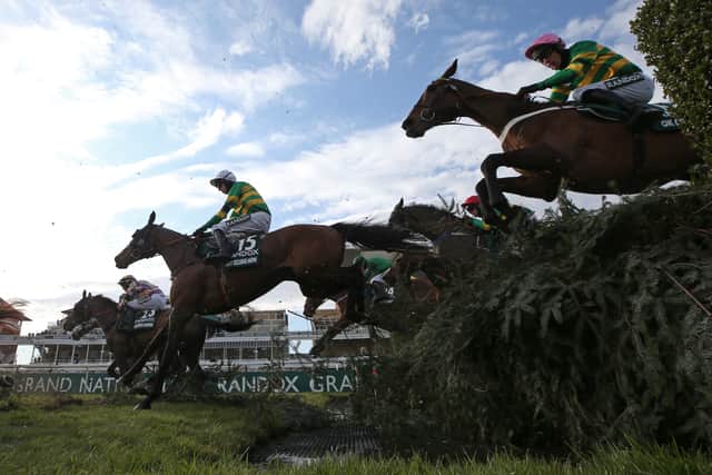 Runners and riders clear the water jump during the Randox Grand National Handicap Chase in 2021. Image: Photo: Tim Goode - Pool/Getty Images