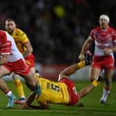 Jack Welsby of St Helens breaks the tackle of Fouad Yaha of Catalans Dragons. Photo: Gareth Copley/Getty Images