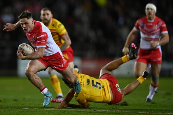 Jack Welsby of St Helens breaks the tackle of Fouad Yaha of Catalans Dragons. Photo: Gareth Copley/Getty Images