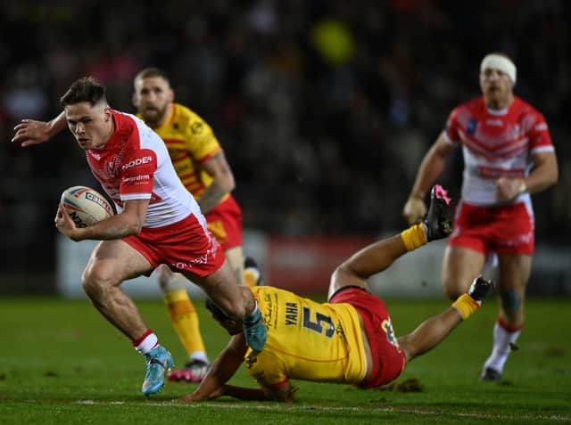 <p>Jack Welsby of St Helens breaks the tackle of Fouad Yaha of Catalans Dragons. Photo: Gareth Copley/Getty Images</p>