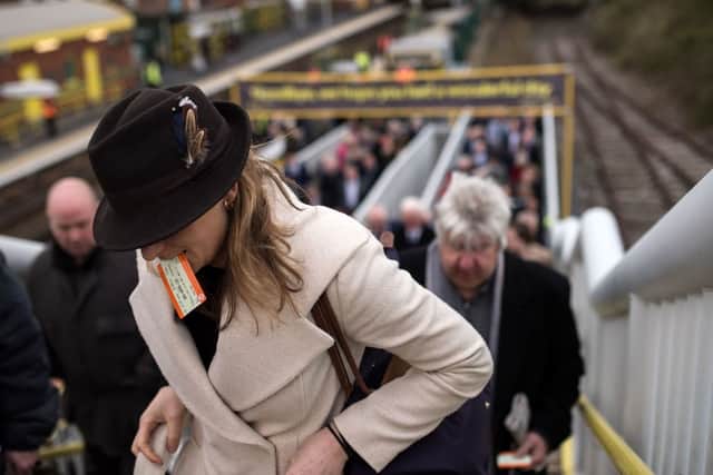 Racegoers arrive at Aintree station to attend the Grand National Festival. Photo: OLI SCARFF/AFP via Getty Images
