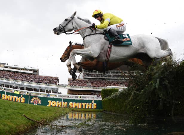<p>Neptune Collonges ridden by Daryl Jacob (C)  jumps the water jump on its way to winning the Grand National horse race at Aintree Racecourse in Liverpool, north-west England on April 14, 2012.  (AFP PHOTO/ANDREW YATES. (Photo: ANDREW YATES/AFP via Getty Images)</p>