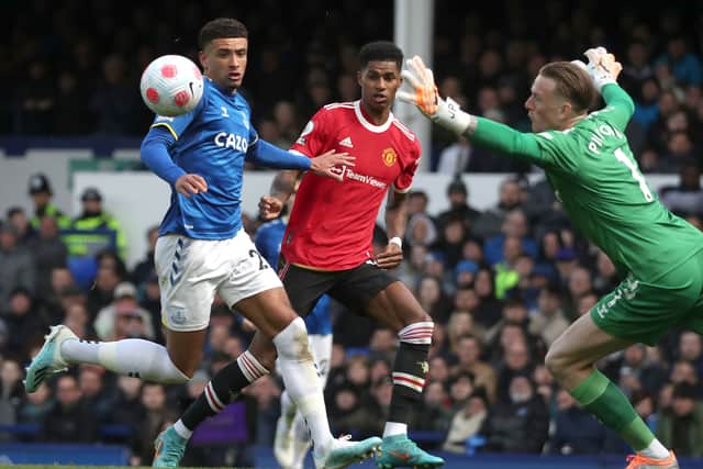 Marcus Rashford of Manchester United in action with Jordan Pickford of Everton during the Premier League match between Everton and Manchester United at Goodison Park on April 09, 2022 in Liverpool, England. (Photo by Tom Purslow/Manchester United via Getty Images)