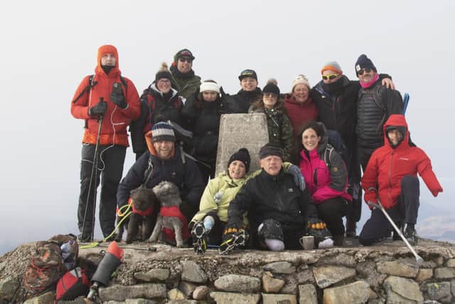 Paul Ellis and the team at the top of Ben Nevis. Photo: Lucy McAlpine Photography/ SWNS