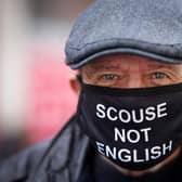 A man wears a ‘Scouse not English' COVID mask during the pandemic. Photo: Christopher Furlong/Getty Images
