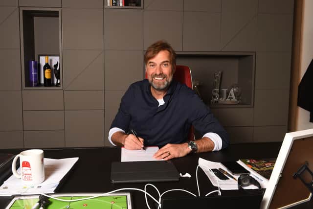 KIRKBY, ENGLAND - APRIL 28: (THE SUN OUT, THE SUN ON SUNDAY OUT) Jurgen Klopp manager of Liverpool signing a contract extension at AXA Training Centre on April 28, 2022 in Kirkby, England. (Photo by Andrew 