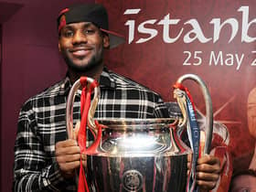 Lebron James poses with the Champions League trophy during a tour of Liverpool’s Anfield stadium. Picture: Andrew Powell/Liverpool FC via Getty Images