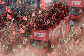 Fans celebrate with the Liverpool team during the open-top bus parade to celebrate winning the UEFA Champions League on June 2, 2019 in Liverpool, England. (Photo by Nick Taylor/Liverpool FC/Liverpool FC via Getty Images