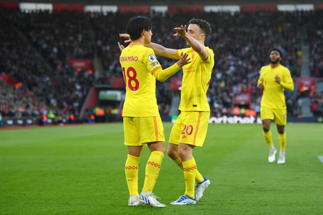 Takumi Minamino of Liverpool celebrates with team mate Diogo Jota after scoring their sides first goal during the Premier League match between Southampton and Liverpool at St Mary's Stadium on May 17, 2022 in Southampton, England. (Photo by Mike Hewitt/Getty Images)