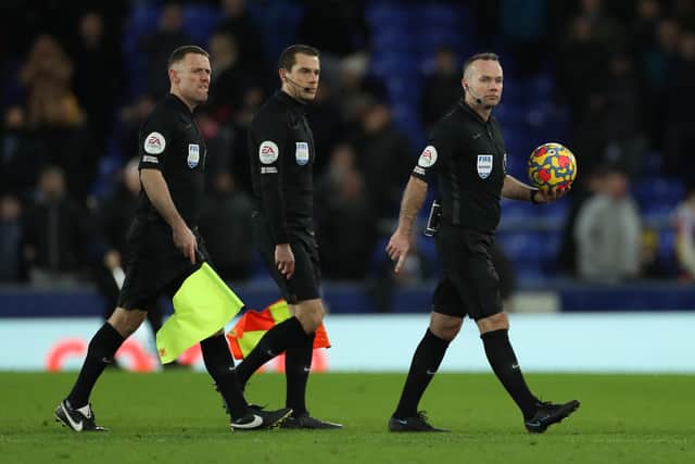  Referee Paul Tierney leaves the pitch with the match ball after the Premier League match between Everton and Manchester City at Goodison Park on February 26, 2022 in Liverpool, England. (Photo by Lewis Storey/Getty Images)