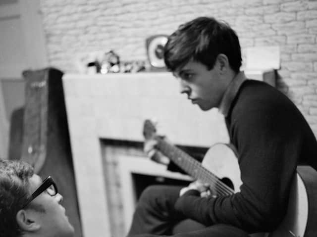 John Lennon and Paul McCartney, writing at 20 Forthlin Road.