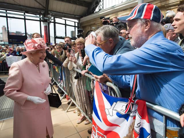 Queen Elizabeth II reacts as she is greeted by wellwishers after arriving by Royal Train at Liverpool Lime Street Station in Liverpool.