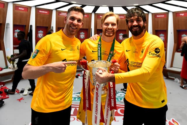 Caoimhin Kelleher celebrates Liverpool’s Carabao Cup triumph with Alisson Becker, right, and Adrian, left. Picture: Andrew Powell/Liverpool FC via Getty Images