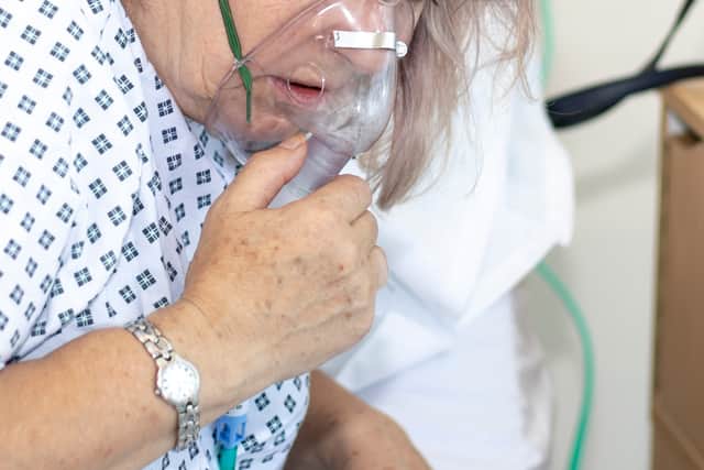 Woman in hospital with breathing difficulties using a respiration mask. Image: Peter - stock.adobe.com