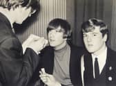 John Hill, right, with John Lennon and an unknown newspaper reporter. Image: David Duggley Auctioneers / SWNS