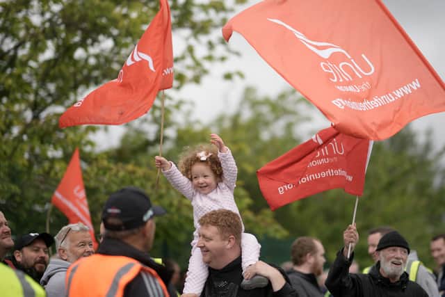 A young girl joins bus drivers and engineers from Stagecoach Merseyside striking outside the company’s Gilmoss depot. (Photo by Christopher Furlong/Getty Images)