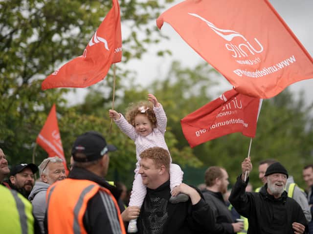 A young girl joins bus drivers and engineers from Stagecoach Merseyside striking outside the company’s Gilmoss depot. (Photo by Christopher Furlong/Getty Images)