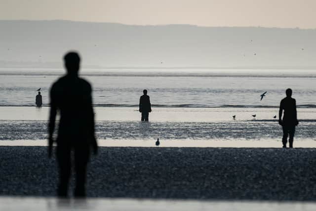 Sculptures making up part of Antony Gormley’s Another Place at Crosby beach. Photo: Christopher Furlong/Getty Images