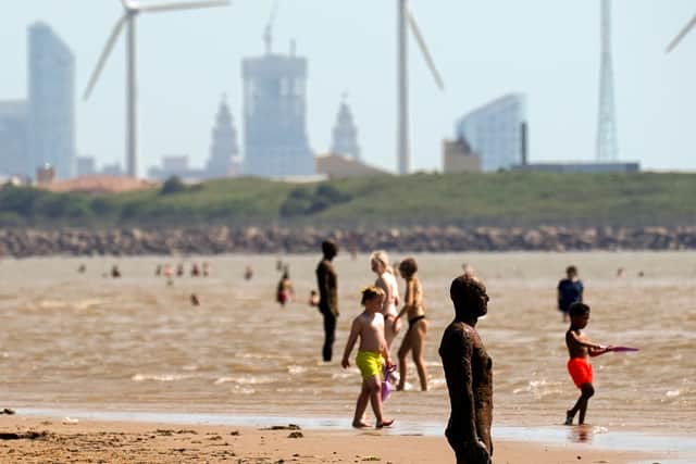 People go for dip in the sea at Crosby Beach to keep cool
