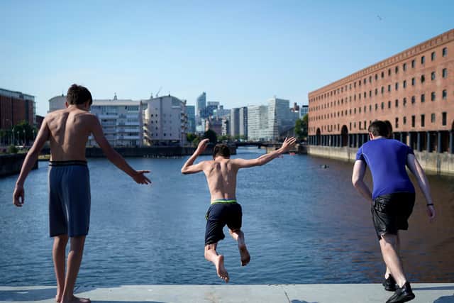 Young people jump into King’s Dock to cool off. Image: Christopher Furlong/Getty Images