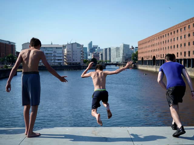 Young people jump into King’s Dock to cool off. Image: Christopher Furlong/Getty Images