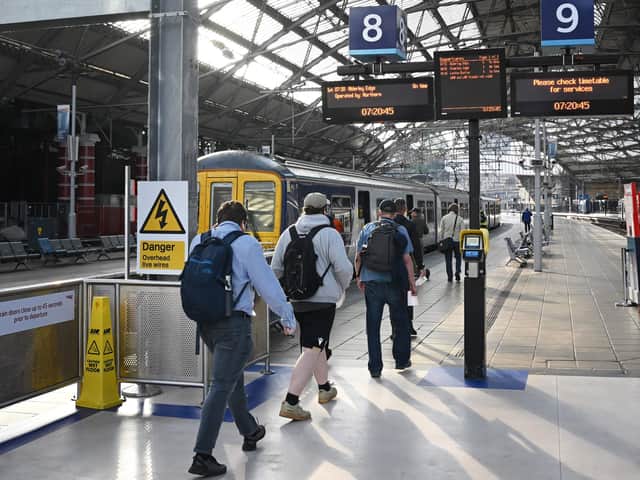 <p>Passengers arrive at Liverpool Lime Street Station. Image: PAUL ELLIS/AFP via Getty Images</p>