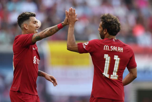 Roberto Firmino celebrates with Liverpool team-mate Mo Salah. Picture: Alexander Hassenstein/Getty Images