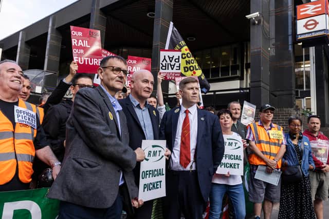 A picket line is joined by Mick Lynch, Secretary-General of the National Union of Rail, Maritime and Transport Workers, (centre)
