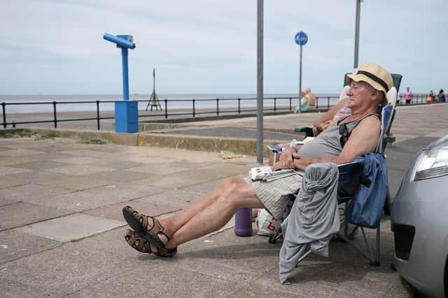 A gentleman lounging at Crosby Beach, Liverpool during the hottest day of the year in Liverpool in July 2022