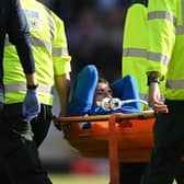 LIVERPOOL, ENGLAND - AUGUST 06: Ben Godfrey of Everton is stretchered off the pitch after receiving medical treatment during the Premier League match between Everton FC and Chelsea FC at Goodison Park on August 06, 2022 in Liverpool, England. (Photo by Michael Regan/Getty Images)
