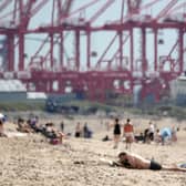  A heat haze shimmers over Crosby Beach as people relax in the warm weather on July 11, 2022 in Liverpool