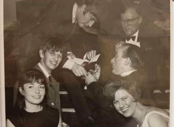 Pictured: Fiona James’ father hands John Lennon a pen. Image: Beatlesauction