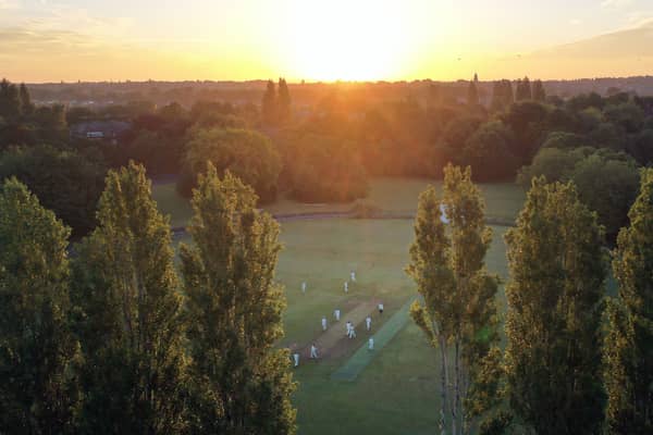 An aerial view shows the sun rising for the Solstice Cricket Match between teams from the Sefton Park Cricket Club in Liverpool